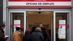 People queue to enter a government employment office as it opens on December 4, 2012 in Madrid, Spain. 