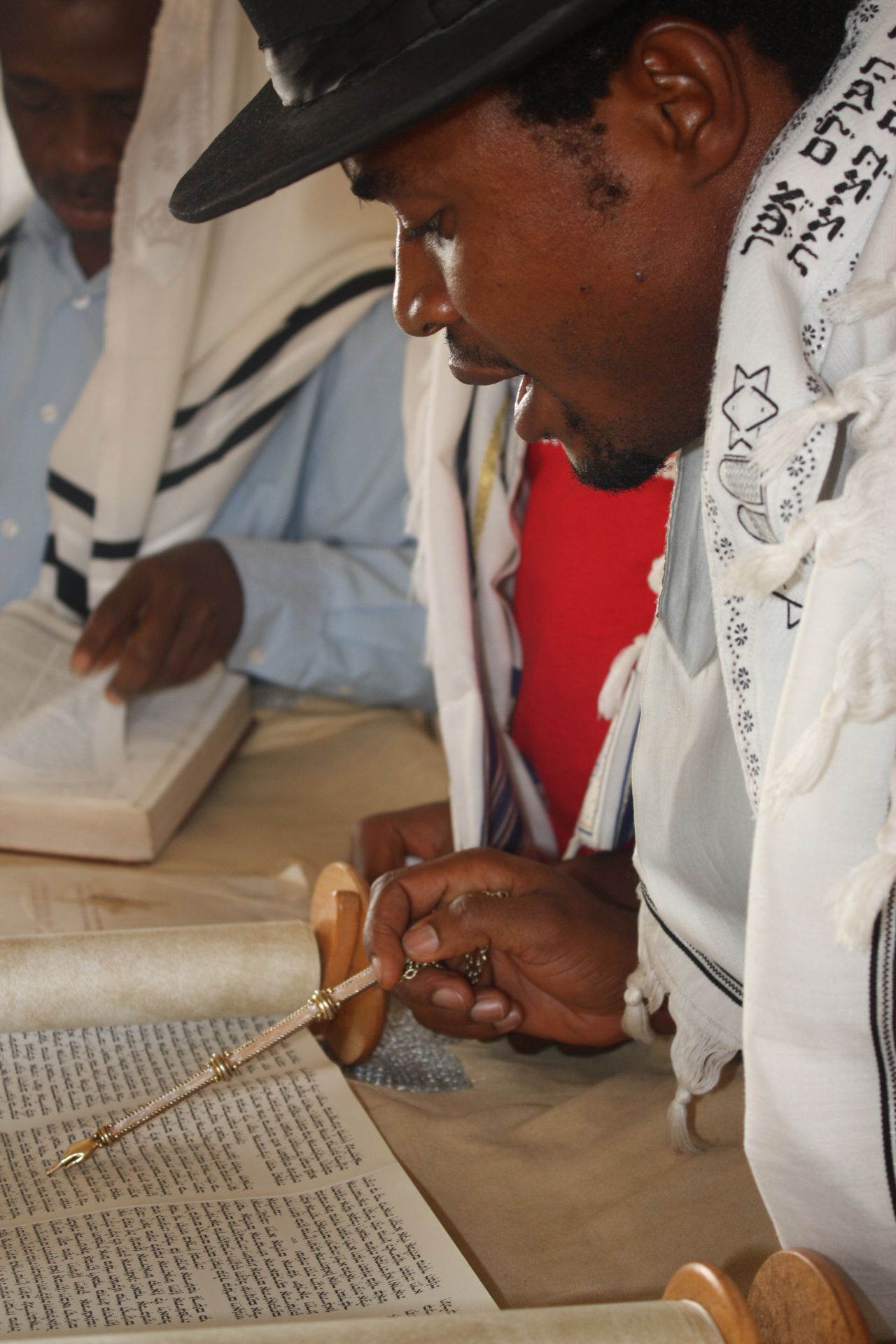 A prayer leader at a synagogue near Abuja reads from the Torah. (Courtesy: Chika Oduah.)