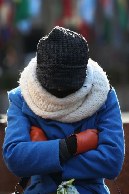 A pedestrian bundled up against the cold walks along a street in Manhattan on January 24.