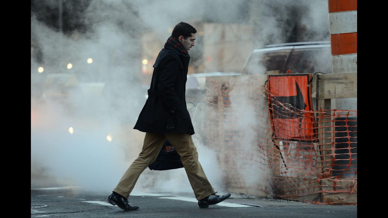 A man walks past a steam vent on Madison Avenue in Manhattan in the early morning of January 24.