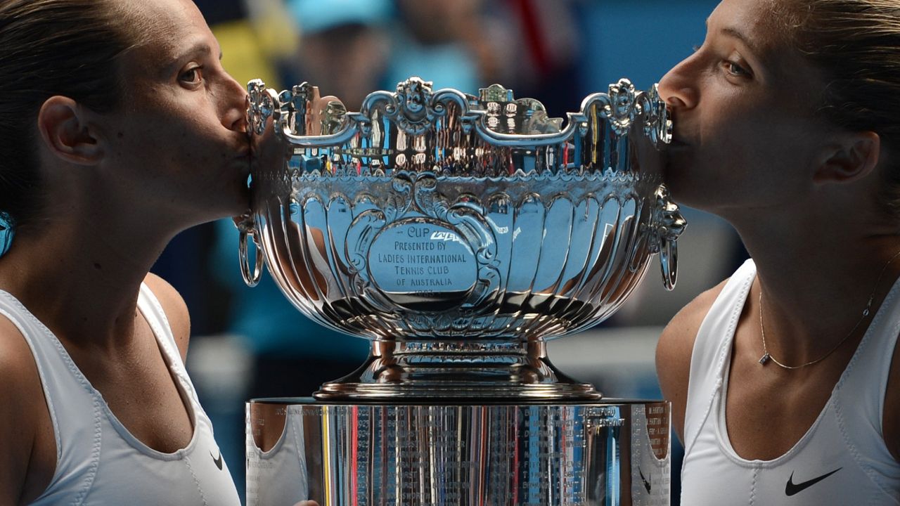 Italy's Roberta Vinci, left, and Sara Errani pose with the winner's trophy after their victory over Australia's Ashleigh Barty and Casey Dellacqua on January 25.