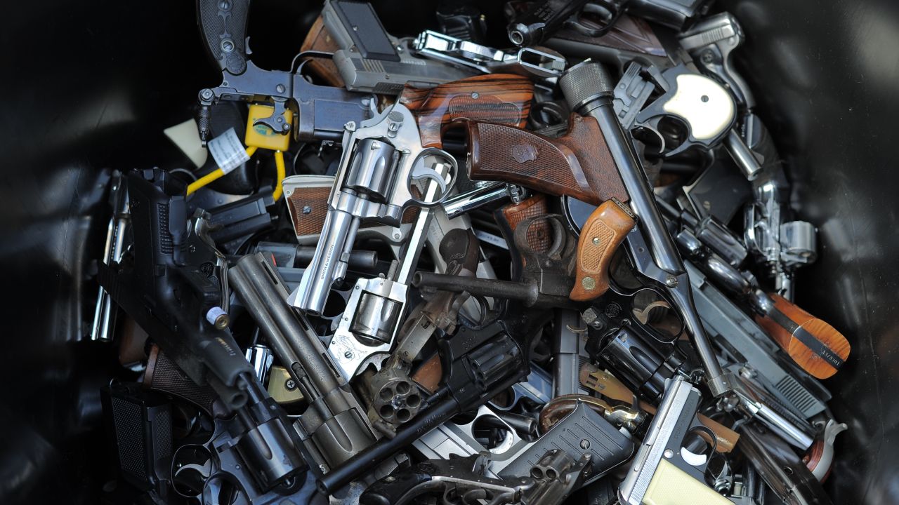 A trash bin holds handguns collected during a recent gun buyback program in Los Angeles.