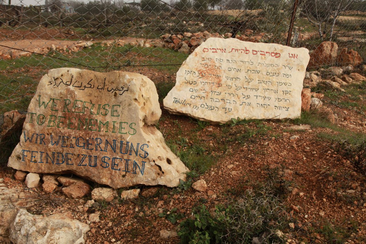 The entrance to the Tent of Nations, 100 acres owned by a Palestinian with a deed that dates to 1916, says, "We refuse to be enemies."