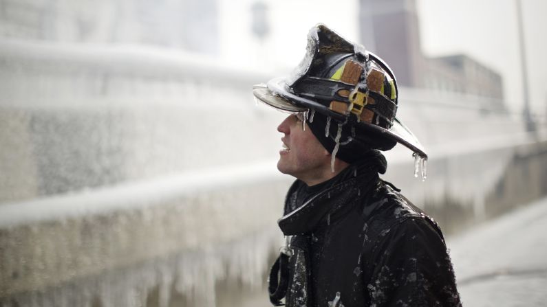 Ice covers firefighter Michael De Jesus while he mans a water cannon at the scene of a warehouse fire in Chicago on January 24.