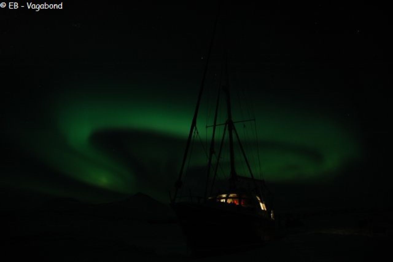 The swirling northern lights in the skies above <em>Le Vagabond</em> in Spitsbergen, Norway.