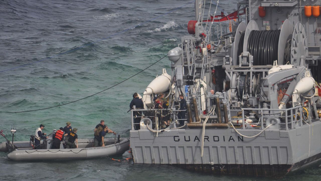 A U.S. Navy salvage assessment team boards the USS Guardian on Wednesday, January 23, in the Sulu Sea.