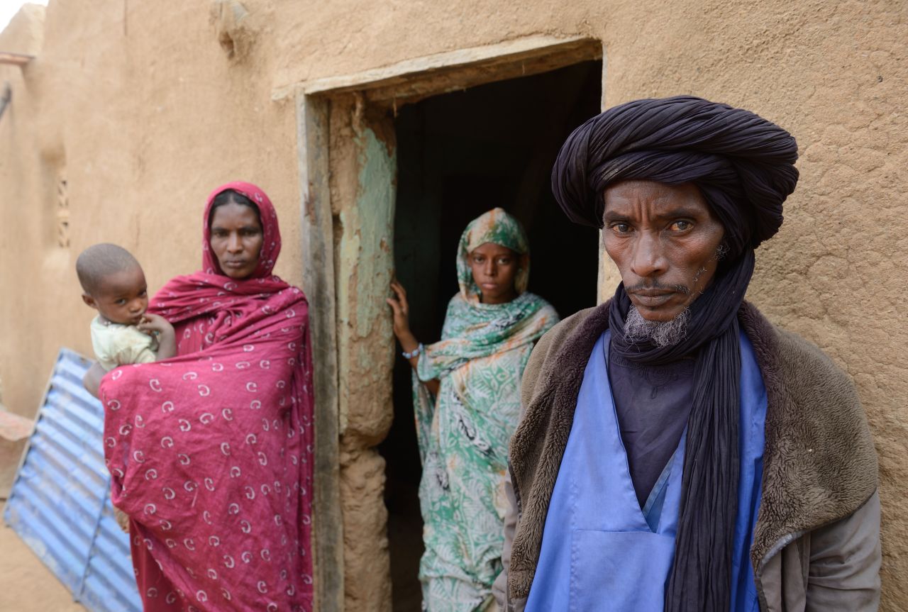 Ali Ag Noh, right, stands with his family in front of his house on Friday, Janurary 25, in the village of Seribala, Mali, after his cousin and brother-in-law, Aboubakrim Ag Mohamed, and a cattle rancher, Samba Dicko, were shot dead on January 24, allegedly by the Malian Army. According to Noh, Mohamed, a Tuareg, and Dicko were shot in the head in Seribala after being accused by two Malian soldiers of being Islamists or aiding Islamists.