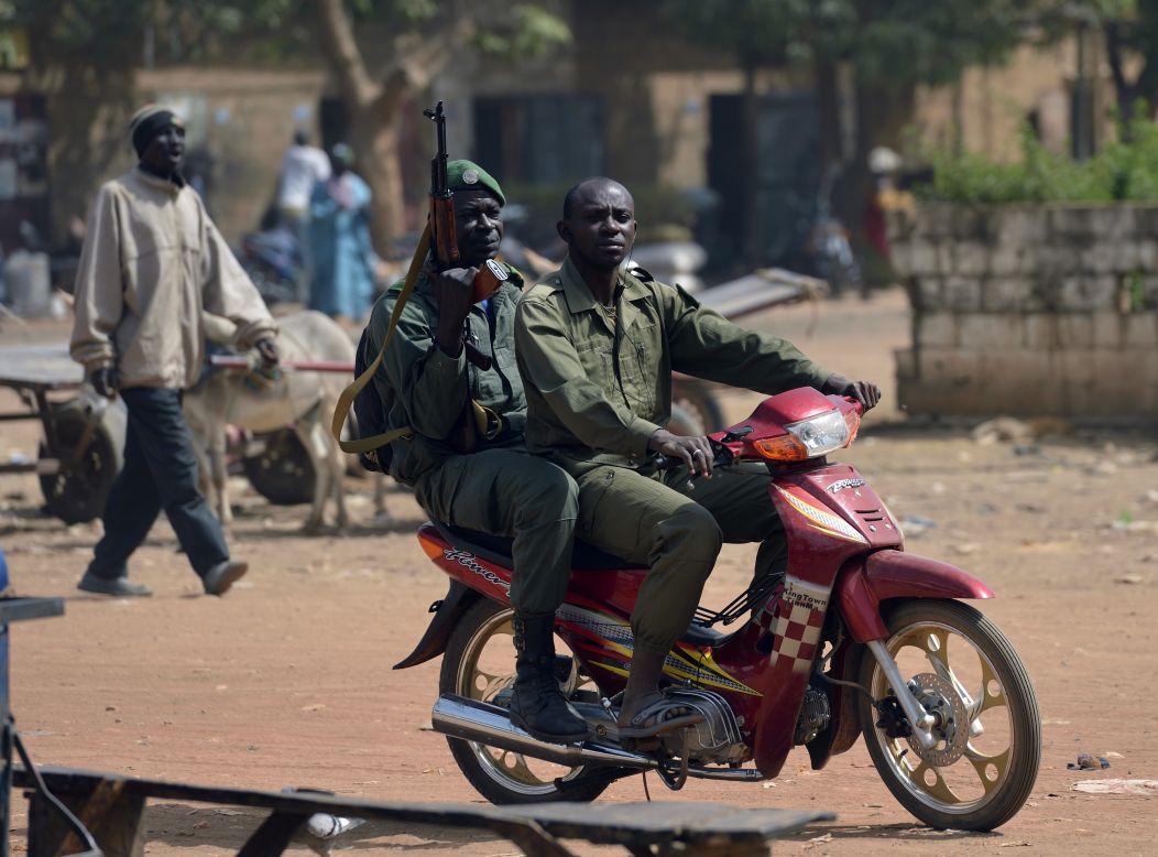 Malian soldiers ride a motorcycle in a street of Merkala, on Thursday, January 24, 2013 as the first of the 6,000 troops pledged by African nations to support France started heading north.
