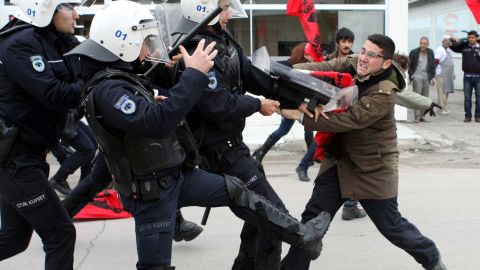 A leftist clashes with Turkish policemen during a January 21 protest in Adana against NATO's installation of Patriot missiles.