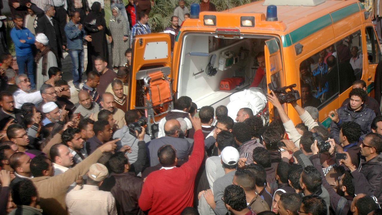 Relatives and friends of Egyptian protesters who were killed in Suez during clashes with riot police Friday, load a body onto an ambulance outside the morgue in Suez on January 26.