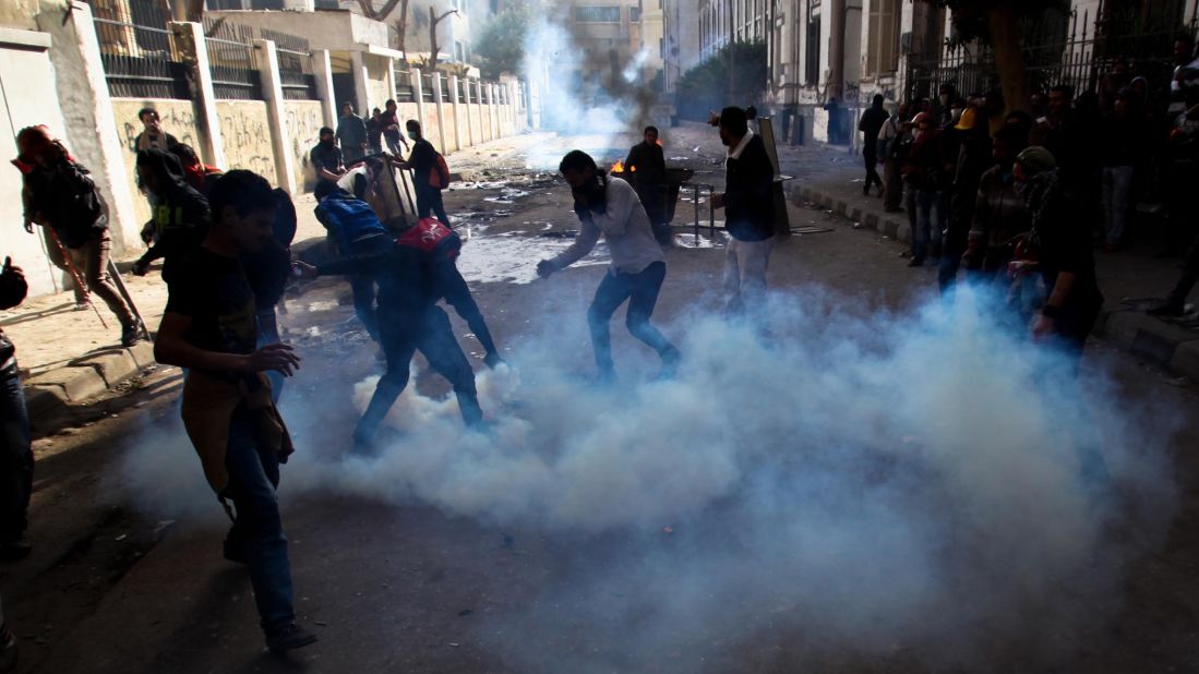 Protesters and football fans clash with riot police near Egypt's interior ministry.