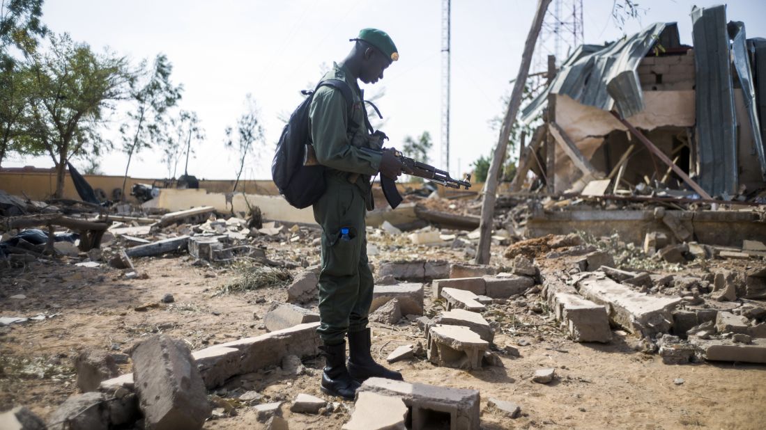 A Malian soldier stands amid debris Saturday, January 26, in the key central town of Konna, which has been under French and Malian army control since last week. It was taken on January 11 by Islamist groups.