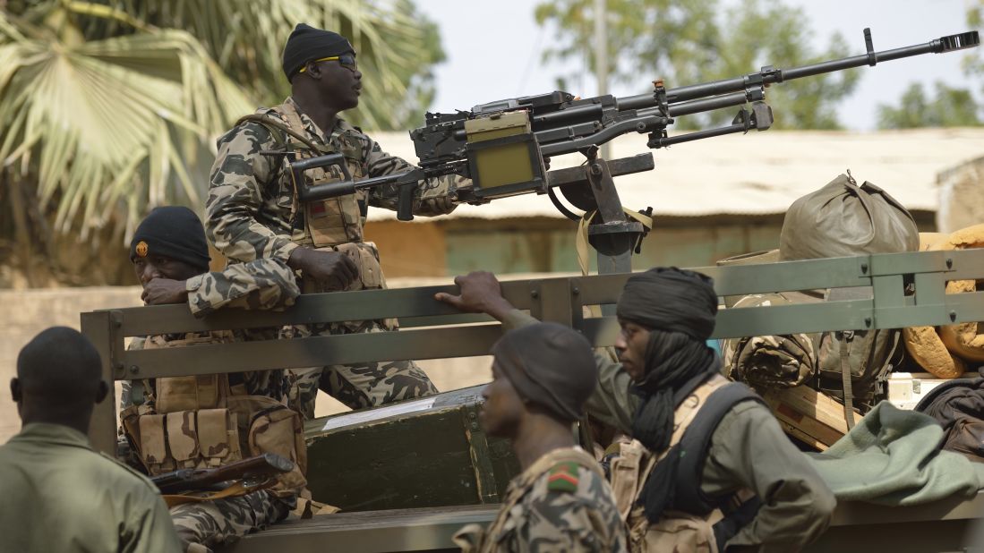 Malian soldiers patrol a street of Diabaly on January 26.