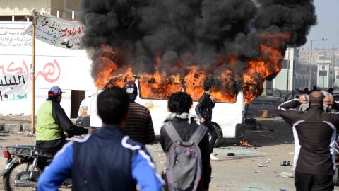 Smoke billows from a burning vehicle set on fire by Egyptian protesters outside the Port Said prison on January 26.