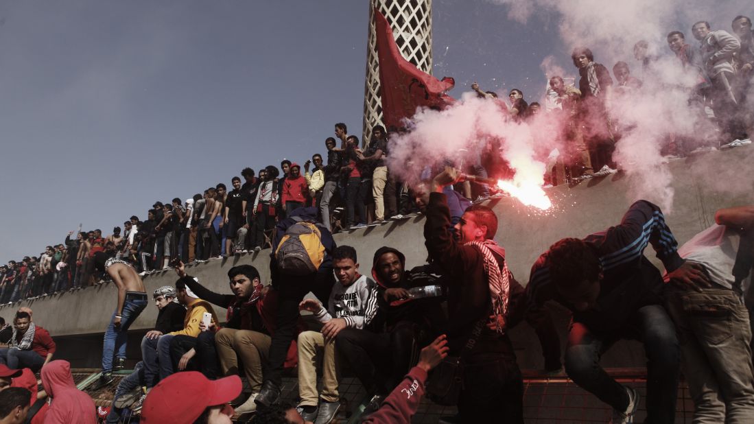 An Al-Ahly soccer fan swings a live flare above his head on January 26 in Cairo.