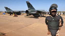 A Malian National Guard stands near Mirages jets of the French army at the 101 airbase near Bamako during a visit of Malian president Dioncounda Traore to the French troops on January 16, 2013. 