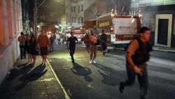 A firefighter, center, carries a body after a fire broke out at a disco in Santa Maria, Brazil, on January 27.