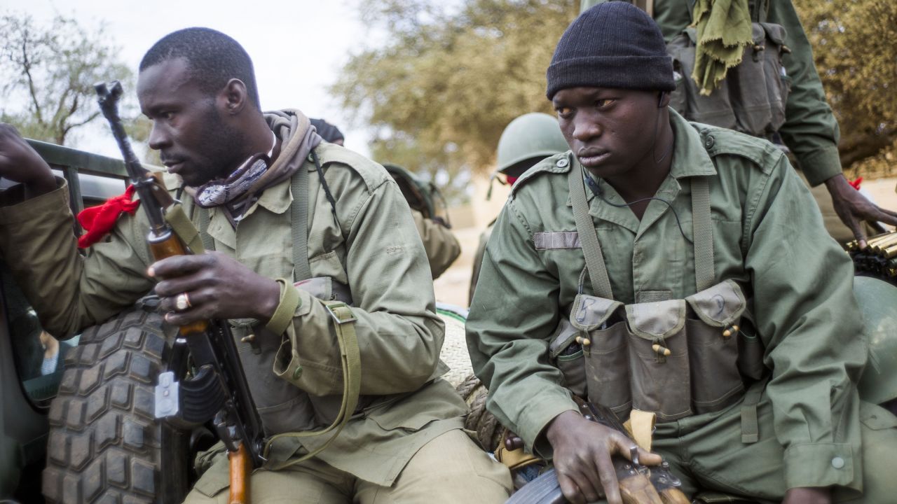 Malian soldiers wait at a checkpoint near Sevare on January 27.