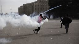 An Egyptian protester throws a live tear gas canister back towards riot police in Tahrir Square on Sunday, January 27 in Cairo, Egypt.