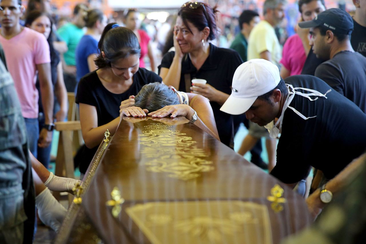 Relatives of a victim of a fire that broke out at the Kiss nightclub weep during the funeral in Santa Maria, Brazil, on Sunday, January 27.