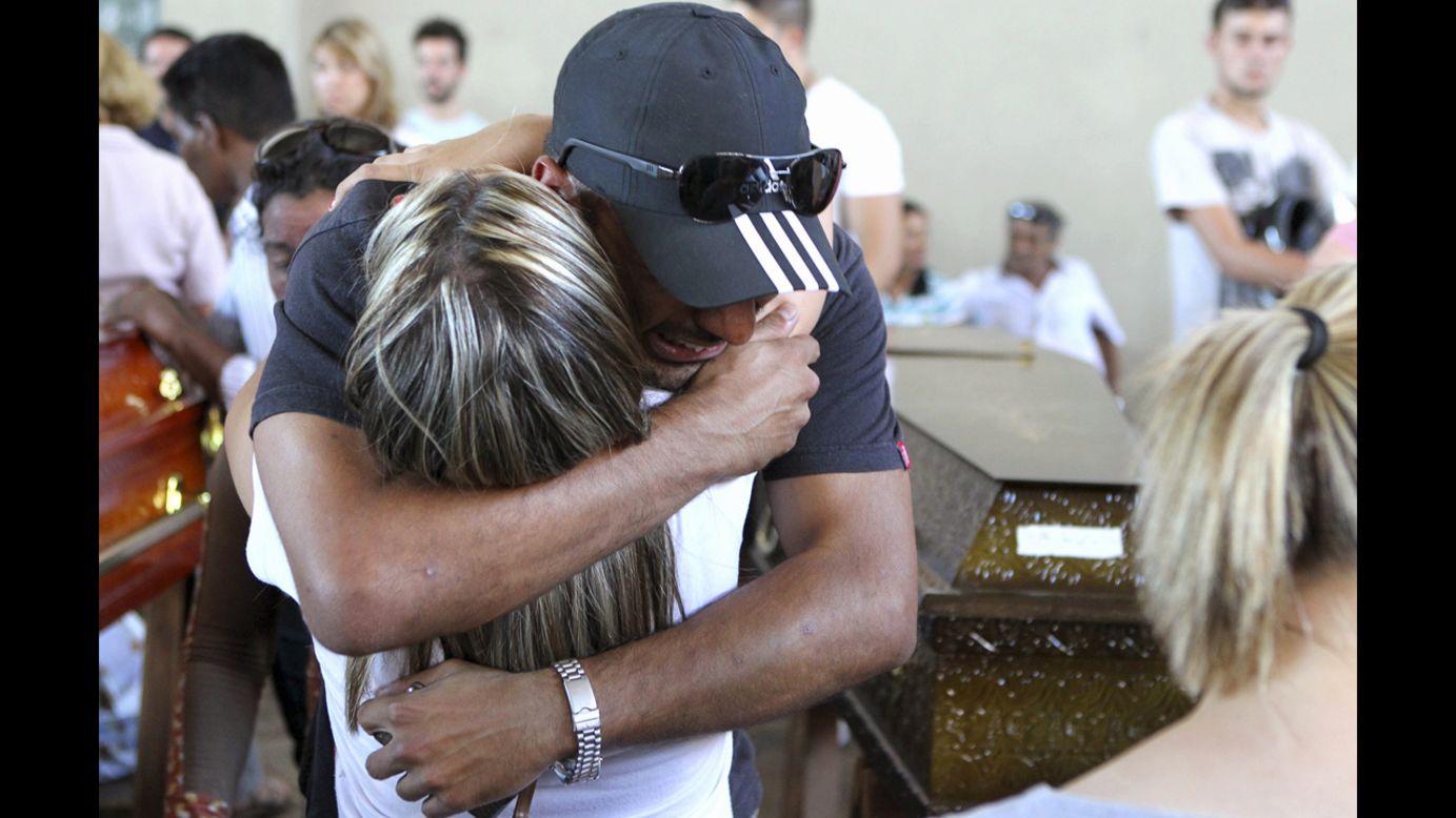 People console each other during a collective wake for the victims of the nightclub fire.