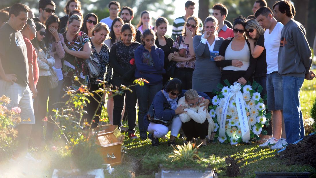 Relatives and friends of one of the victims of the Kiss nightclub fire gather during the funeral at Santa Rita Cemetery in Santa Maria on January 28.