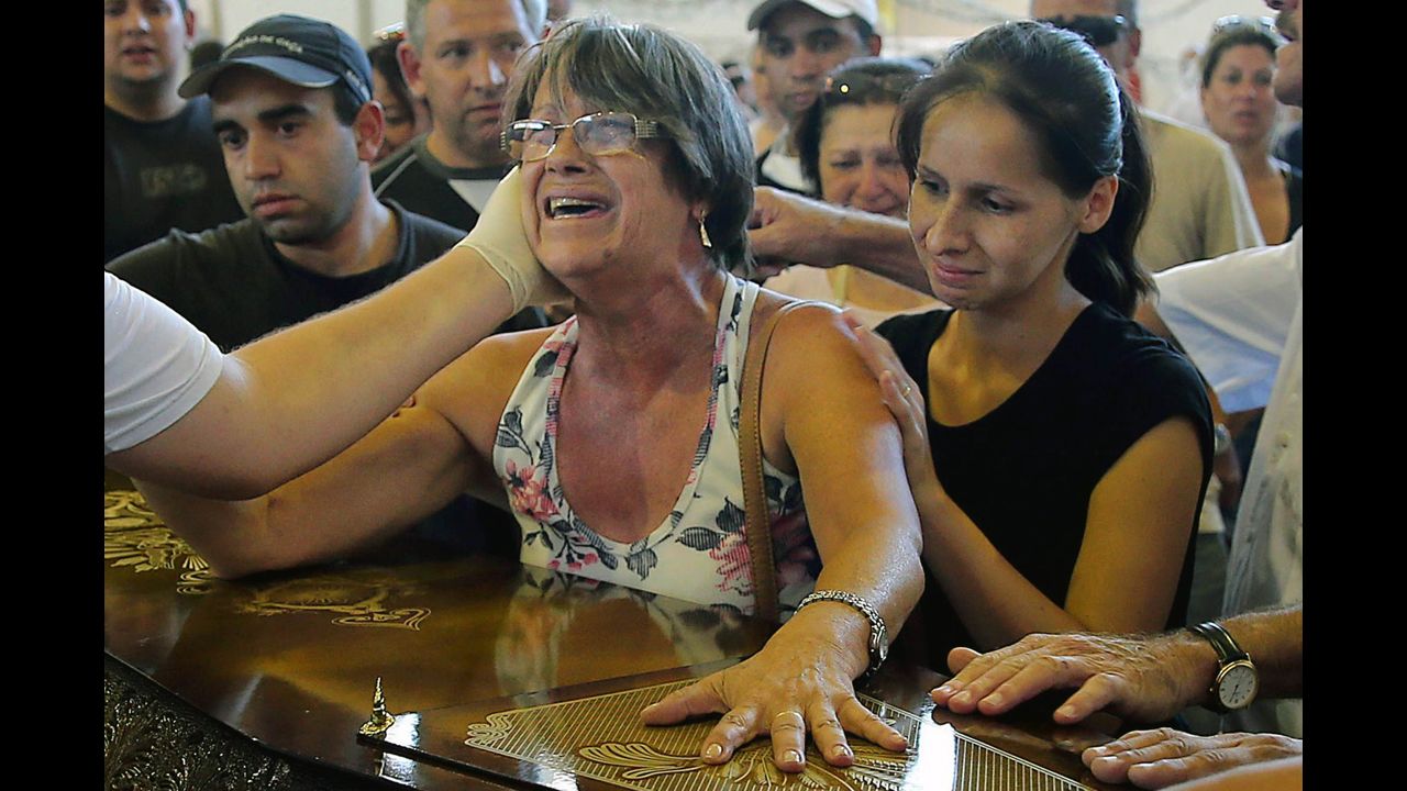 Relatives of victims weep during a funeral in Santa Maria on January 27.