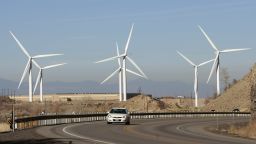  	SPANISH FORK, UT - NOVEMBER 24: A car makes it's way up U.S. Highway 6 as several 2.1 mega watt wind powered turbines owned by Edison Mission Energy, sit a the mouth of Spanish Fork Canyon November 24, 2008 in Spanish Fork, Utah. Each turbine is 300 feet tall, with three 150 foot blades. Deputy Assistant Secretary of Land and Minerals Management at the Department of the Interior, Michael D. Olsen, said the potential for production of wind energy on public lands in the West is 'tremendous,' with the alternative energy source already accounting for the fastest growing energy sector in the U.S. Last year the U.S. saw a 46 percent increase in wind capacity and $9 billion in new investments, he said. (Photo by George Frey/Getty Images) 