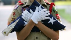 A Boy Scout holds a flag that was to be raised at Zachary Taylor National Cemetery May 26, 2007 in Louisville, Kentucky. Boy Scouts from the Seneca Distrct and the Lincoln Heritage Council, which represents the Louisville area, particpated in the flag placing. This was the 25th year that scouts have been placing flags on the graves at the cemetery. (Photo by Andy Lyons/Getty Images) 
