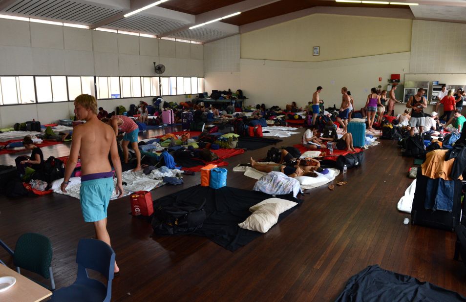 Tourists and local residents take shelter at an evacuation center in Bundaberg, Queensland, on January 28. Thousands of people have been evacuated from their homes.
