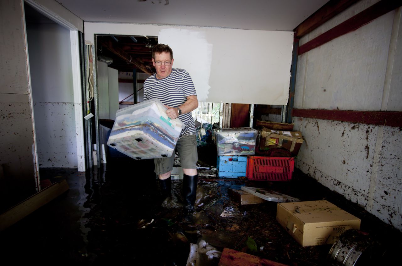 Lindsay Enright starts to clean up the flooded area of his Cullen Street home in Newmarket on January 28.