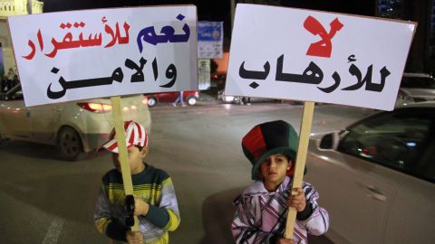 Children in Benghazi hold up placards reading "No to terrorism" (R) and "yes for stability and security" on January 15.