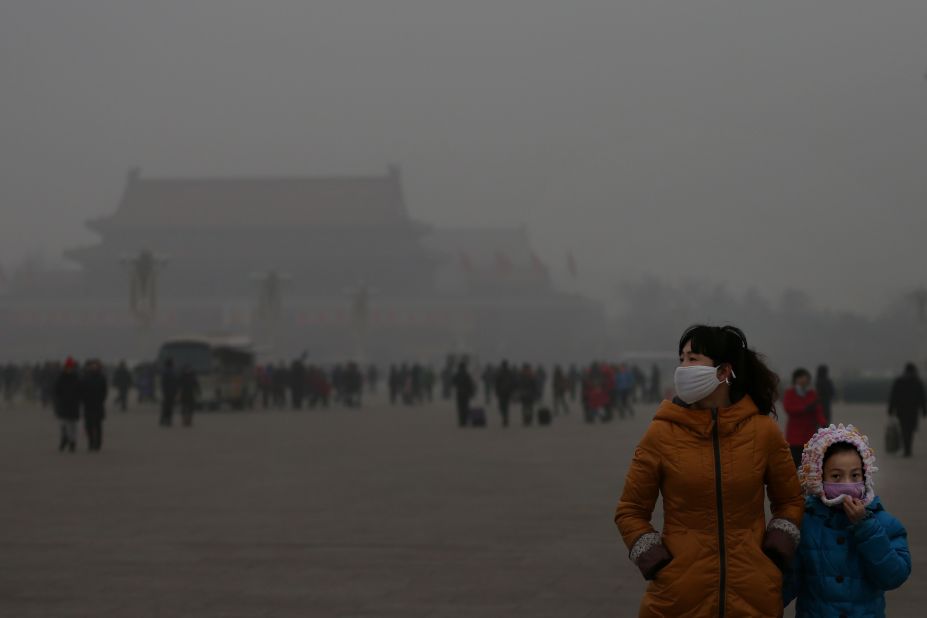  A tourist and her daughter visit Tiananmen Square during dangerous levels of air pollution on January 23.