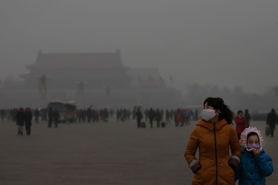  A tourist and her daughter visit Tiananmen Square during dangerous levels of air pollution on January 23.