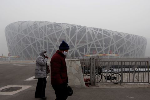 Beijing residents walk by the Bird Nest in Olympic Park on January 29.