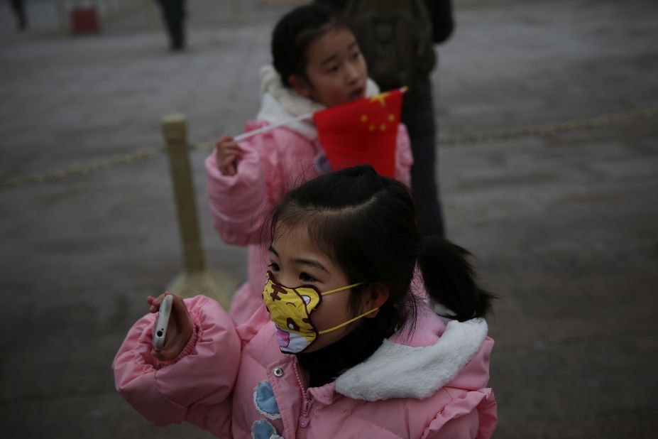A little girl wears a cartoon mask on January 29 at Tiananmen Square to protect herself from pollution.