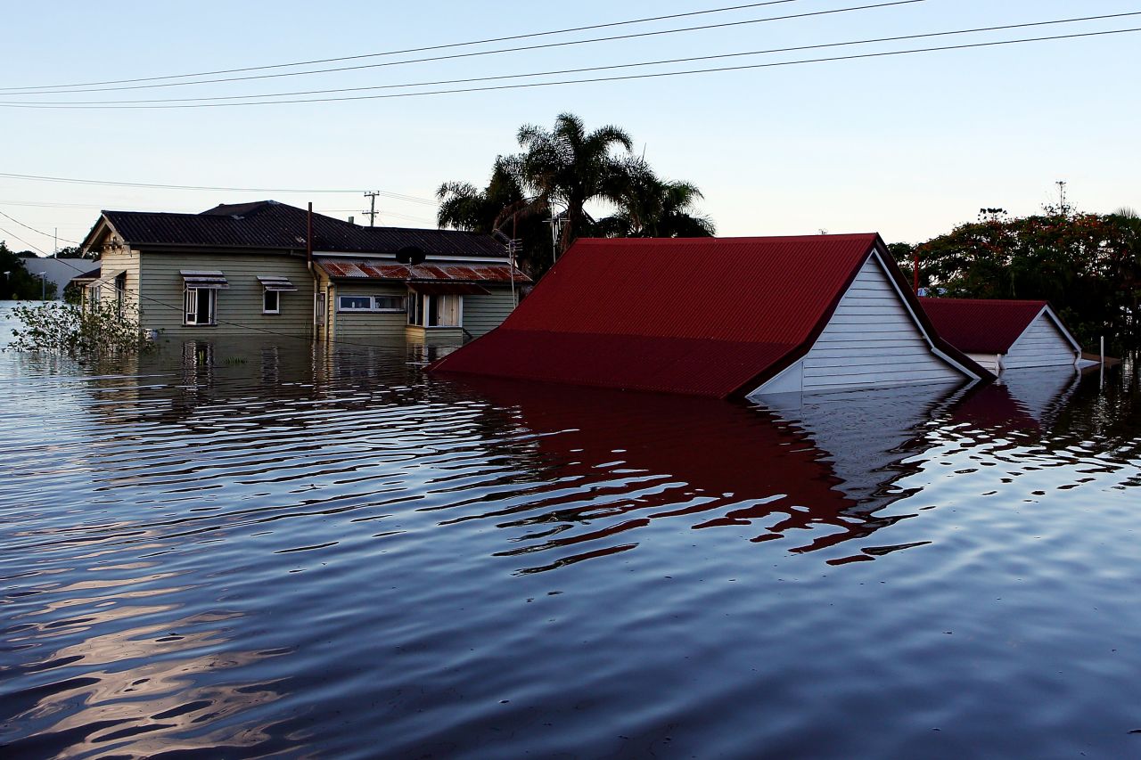  Water engulfs houses in Bundaberg on January 29. The town's hospital has been evacuated as floodwaters advance.