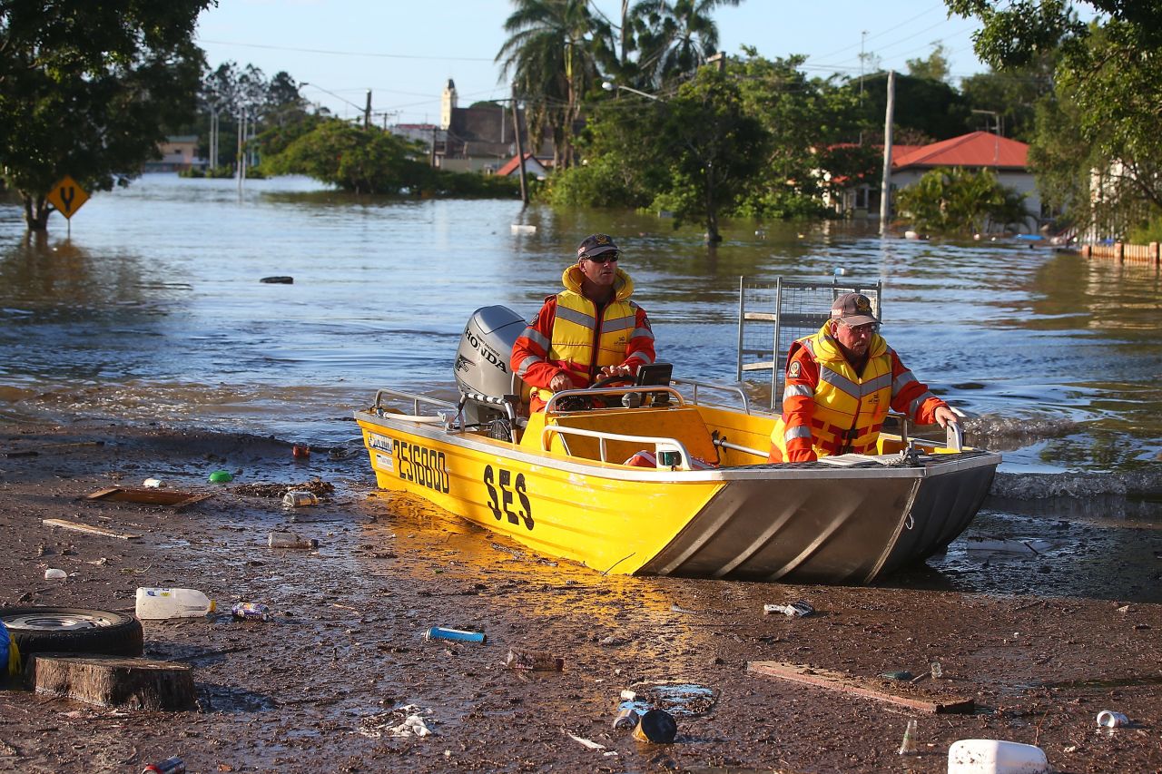 Emergency workers patrol flooded streets by boat in Bundaberg on January 29. The coastal town northwest of Brisbane has been particularly hard hit.