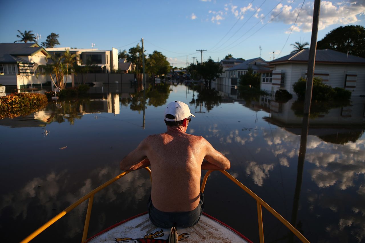 A man checks out flood damage to houses in Bundaberg, Australia, on Tuesday, January 29