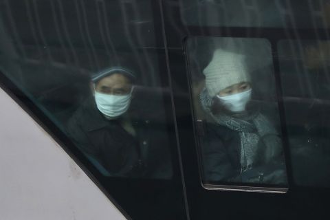 The pollution forces residents of Beijing to wear masks as they ride the bus on January 30.