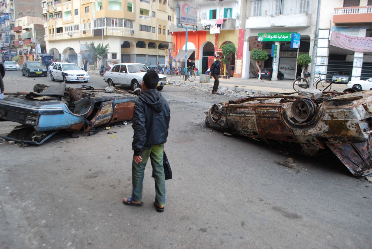 The following day, after the protest, burnt out cars remained in the street.