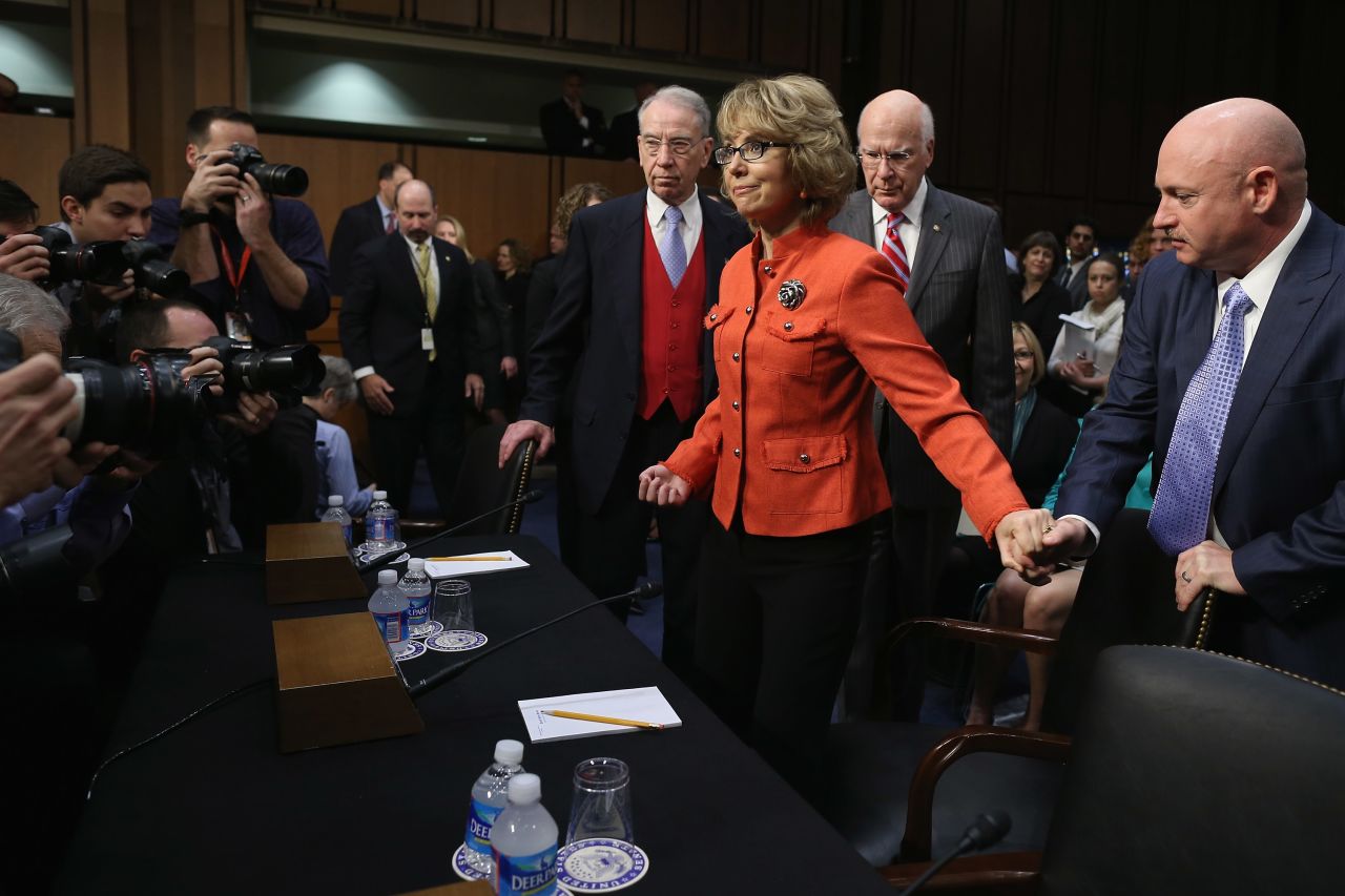 Former Rep. Gabrielle Giffords (D-AZ) takes her seat at a Senate Judiciary Committee hearing about gun violence. Giffords was wounded in a January, 2011 shooting. Her husband, retired NASA astronaut and Navy Capt. Mark Kelly holds her hand.