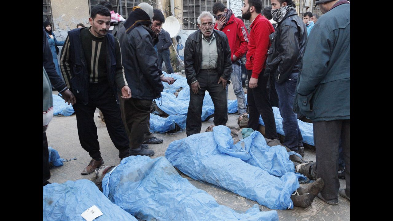 Residents inspect the bodies.