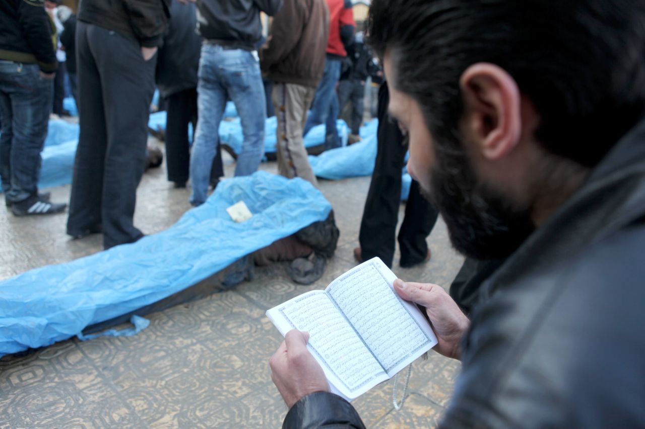 A man reads prayers for the dead.