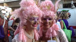 Two ladies from the Krewe of Cork display their Carnival attire during an afternoon parade through the French Quarter.
