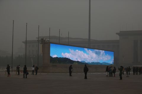 A stark comparison between the clear blue sky image on this LED screen in Tian'anmen Square, January 2013, against the grey smog reality. Beijing saw record levels of air pollution at the turn of the new year. 