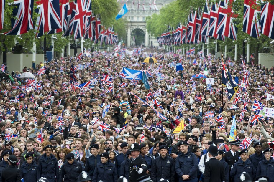 Crowds cheer and wave Union Jacks as they march down the Mall toward Buckingham Palace to celebrate the Queen's Diamond Jubilee in London on June 5, 2012. 
