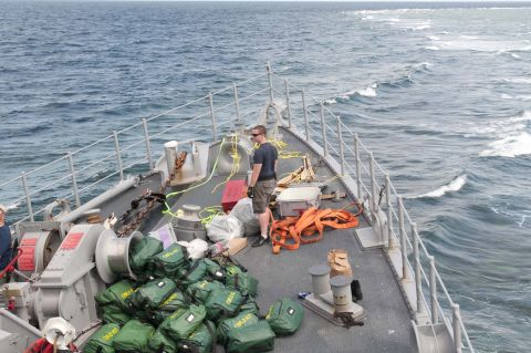 In this undated photo, a U.S. Navy diver moves damage control equipment and other materials to be unloaded from the USS Guardian.