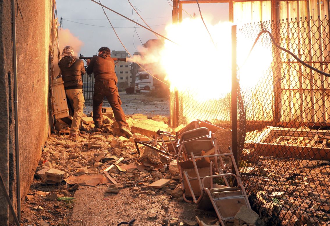 A rebel fighter fires a rocket-propelled grenade during heavy fighting.