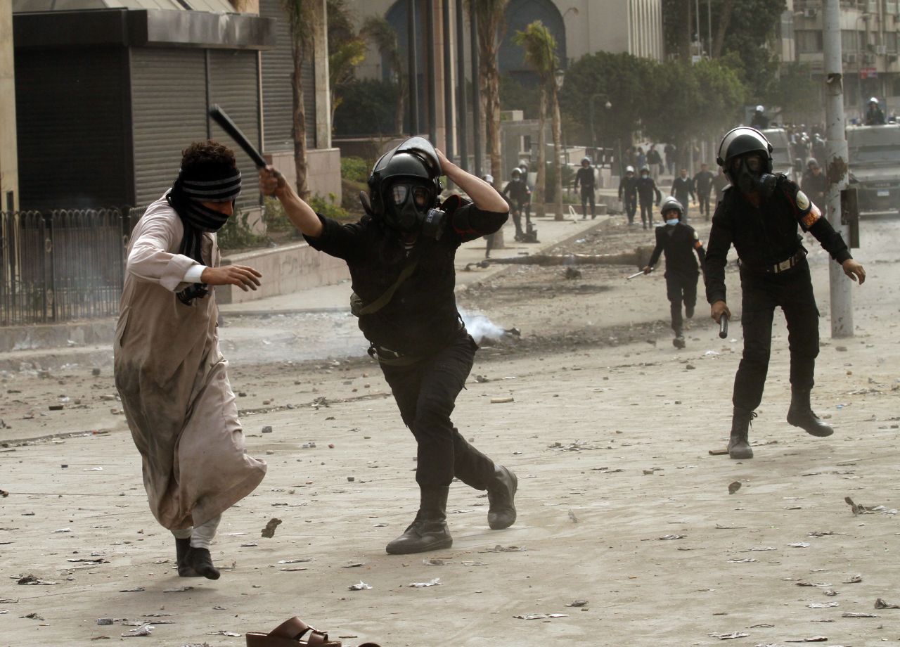 A riot police officer clashes with a protester near Cairo's Tahrir Square on January 28.